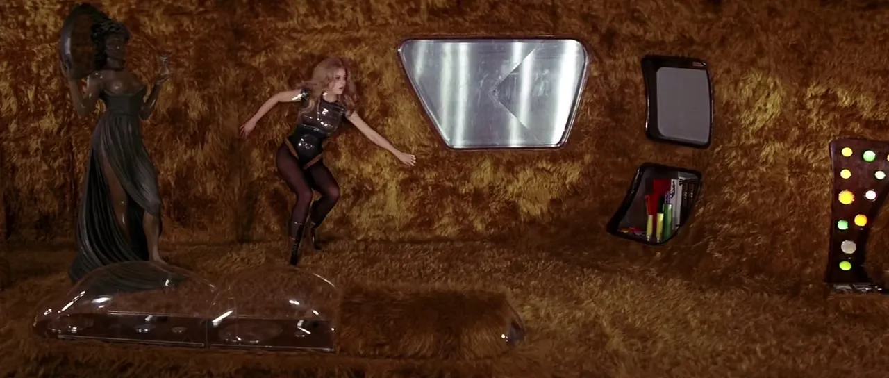 Barbarella in the shagpile cockpit of her spaceship