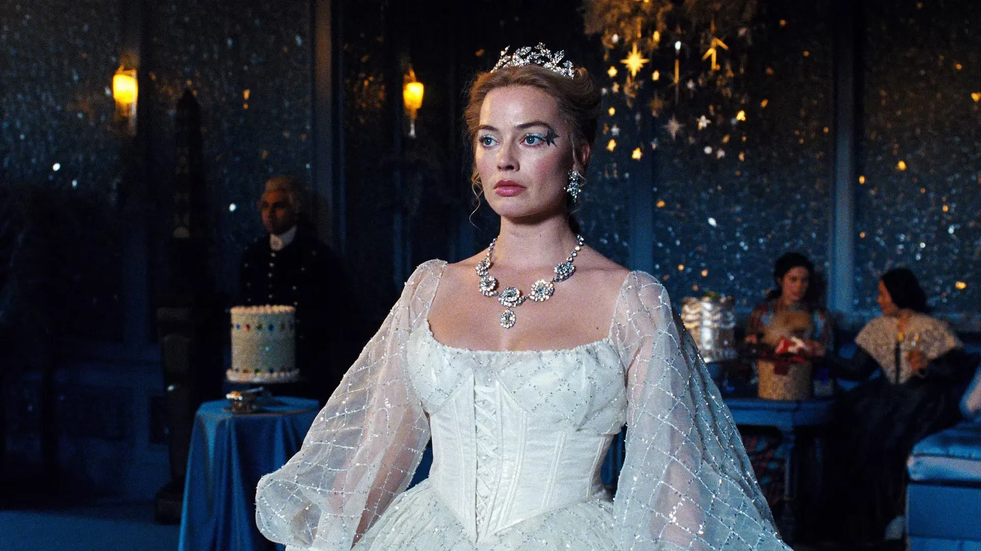 Cathy Earnshaw wearing a white winter-style dress with sheer glittery sleeves in the drawing room at Thrushcross Grange.