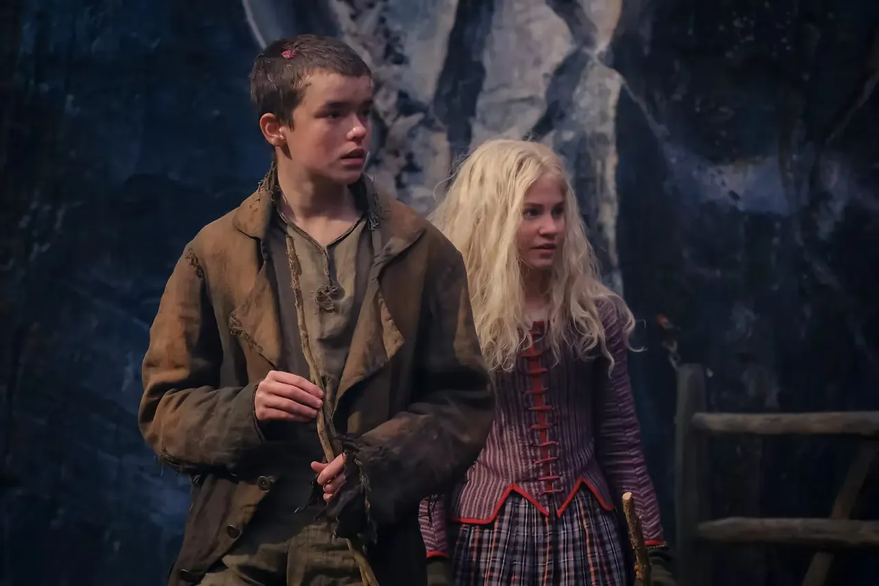 Young Heathcliff, played by Owen Cooper, and young Cathy, played by Charlotte Mellington, at the rough-hewn Wuthering Heights set.